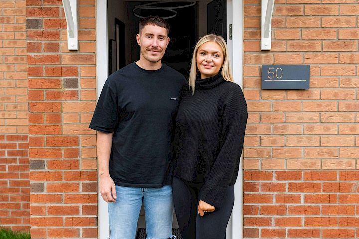 Couple standing in front of a doorway