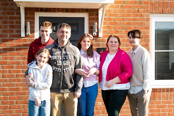 Family standing outside their home