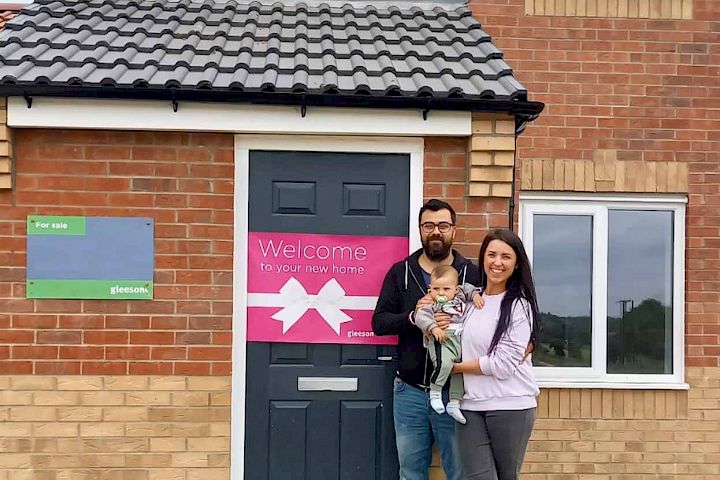 couple and baby at the front door