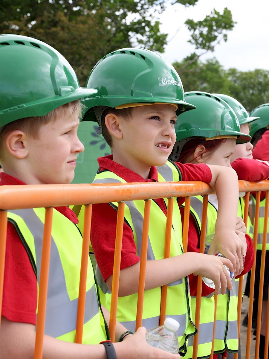 School children in PPE and Gleeson hardhats.