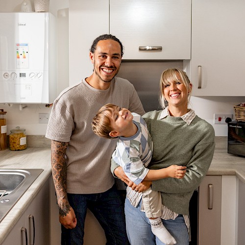 Family smiling in kitchen